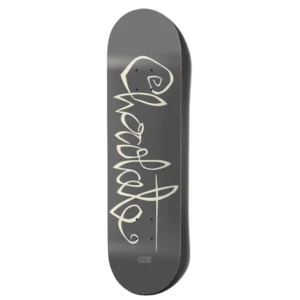 Dark gray skateboard deck with white cursive graphics running lengthwise and small brand text at the tail.